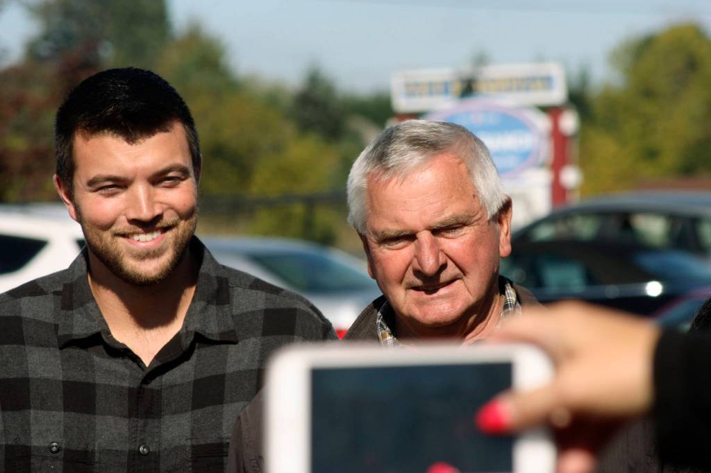 Larry Person, right, and his nephew, David ONeal, appear at an award-recognition ceremony outside Reber Ranch on Sept. 26. Person and ONeal operate Sidetrack Distillery, a finalist for the King County Rural Small Business of the Year award. MARK KLAAS, Kent Reporter