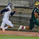 Auburn quarterback Calvin Liulamaga runs for a touchdown, with Auburn Mountainviews Mark Tischenko in pursuit during first-half NPSL action Friday night. RACHEL CIAMPI, Auburn Reporter