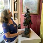 Charlotte Gollnick, a member of Auburn Valley Creative Arts, takes in some of the local works on display at the groups recently-opened pop-up gallery at The Villas at Auburn, a new apartment complex. MARK KLAAS, Auburn Reporter