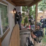 Task force members get ready to raid a house at an unspecified location in July during a crackdown on gang members. COURTESY PHOTO, U.S. Marshals Service