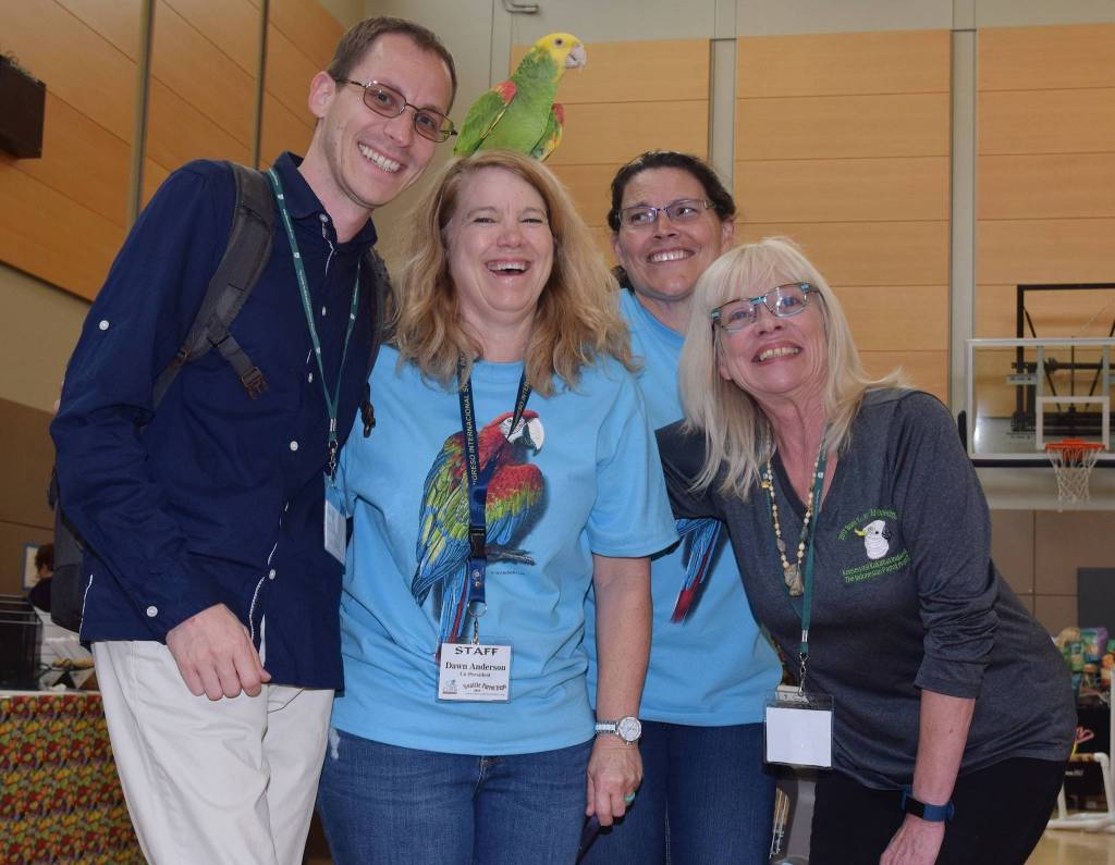 George Olah, Dawn Anderson, and Bonnie Zimmermann, with Parrot Lady Debbie Goodrich and parrot Vegas, take in the expo. RACHEL CIAMPI, Auburn Reporter