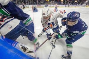 The Thunderbirds Jaxan Kaluski, right, battles the Blazers Martin Lang for the puck along the boards during WHL play Friday night. COURTESY PHOTO, Brian Liesse, T-Birds