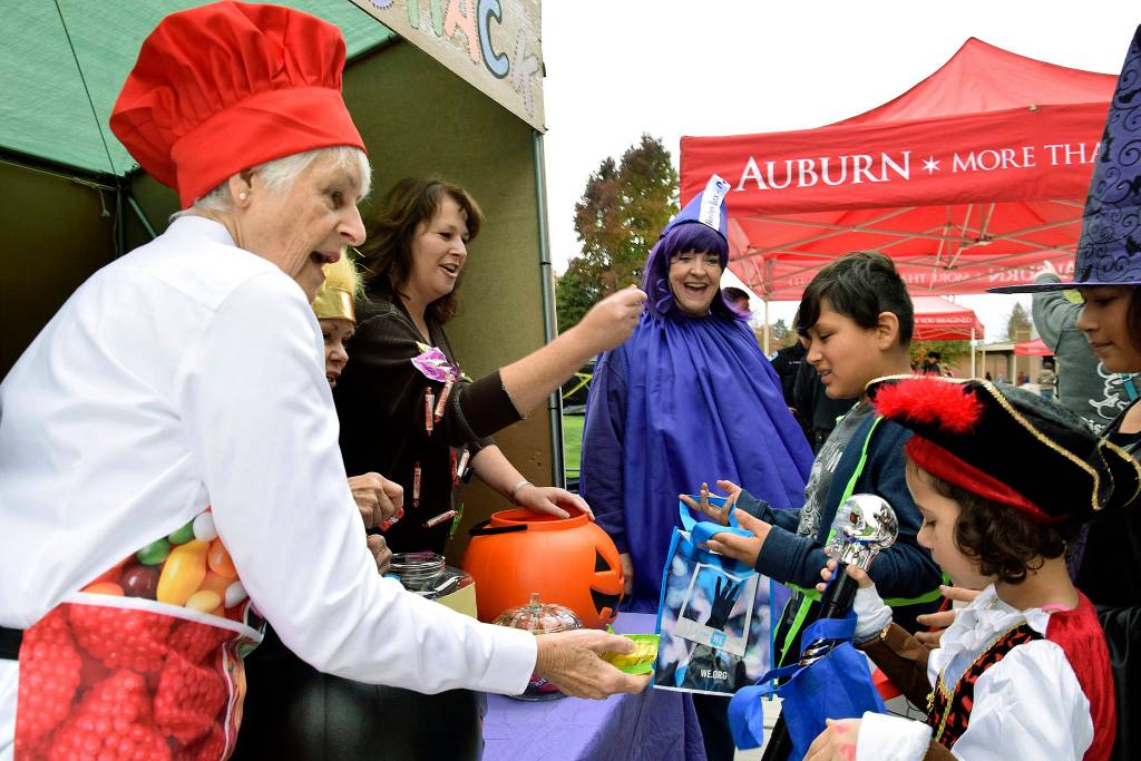 Auburn Police volunteers give out candy to trick-or-treaters at their sugar shack.