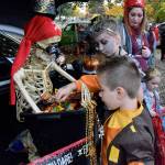 Krystal Sanders as a pirate has Shaylee Bonzan, 9, and Landon Gregory, 7, get candy from the treasure chest. RACHEL CIAMPI, Auburn Reporter