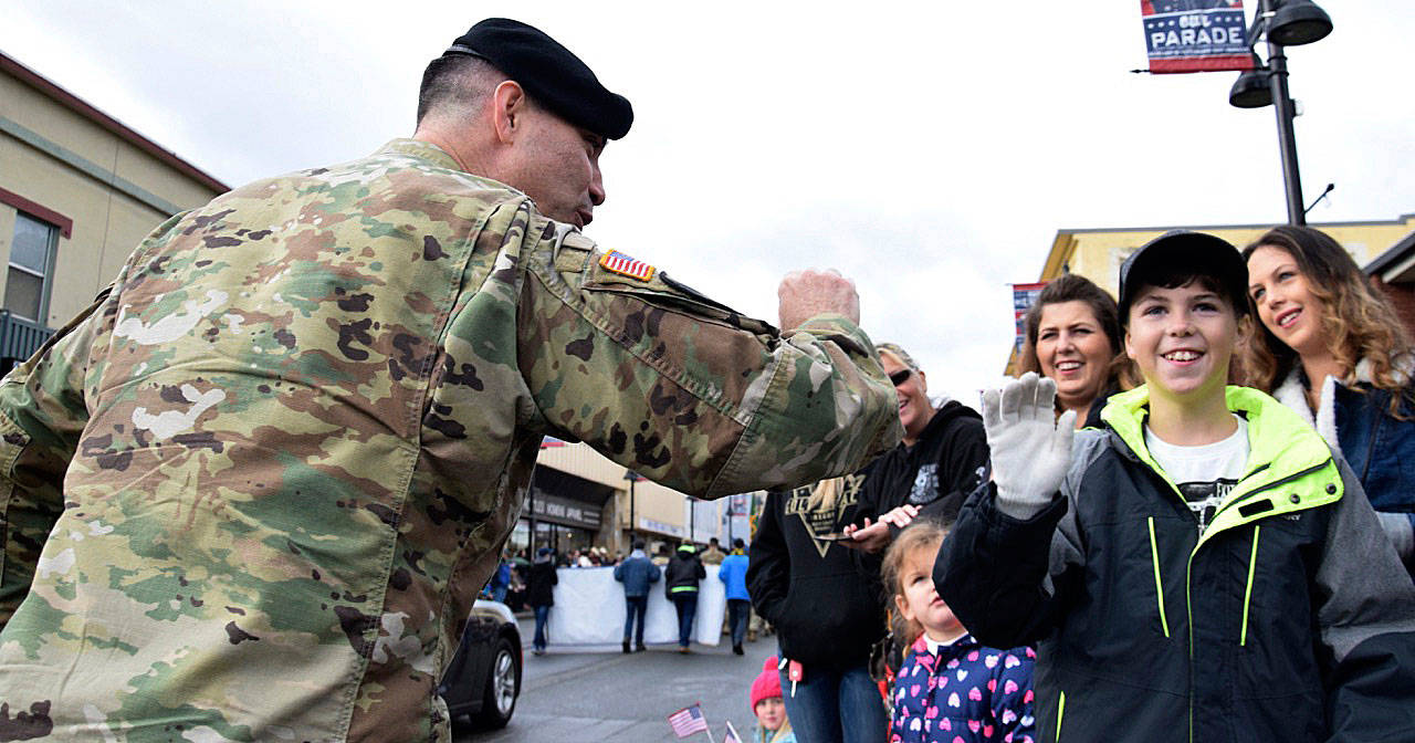 A veteran greets Keenan Stone along Main Street during last years Auburn Veterans Parade. RACHEL CIAMPI, Auburn Reporter