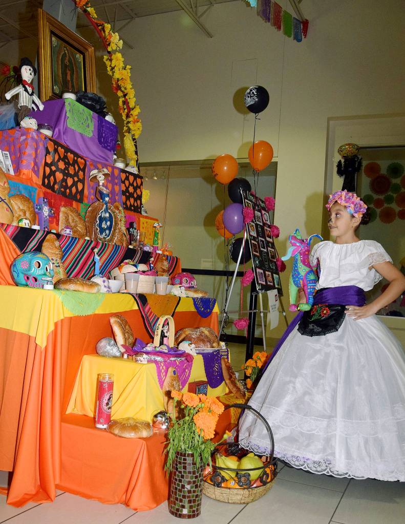Left, Naomi Santivanez, 8, looks at one of the altars. RACHEL CIAMPI, Auburn Reporter