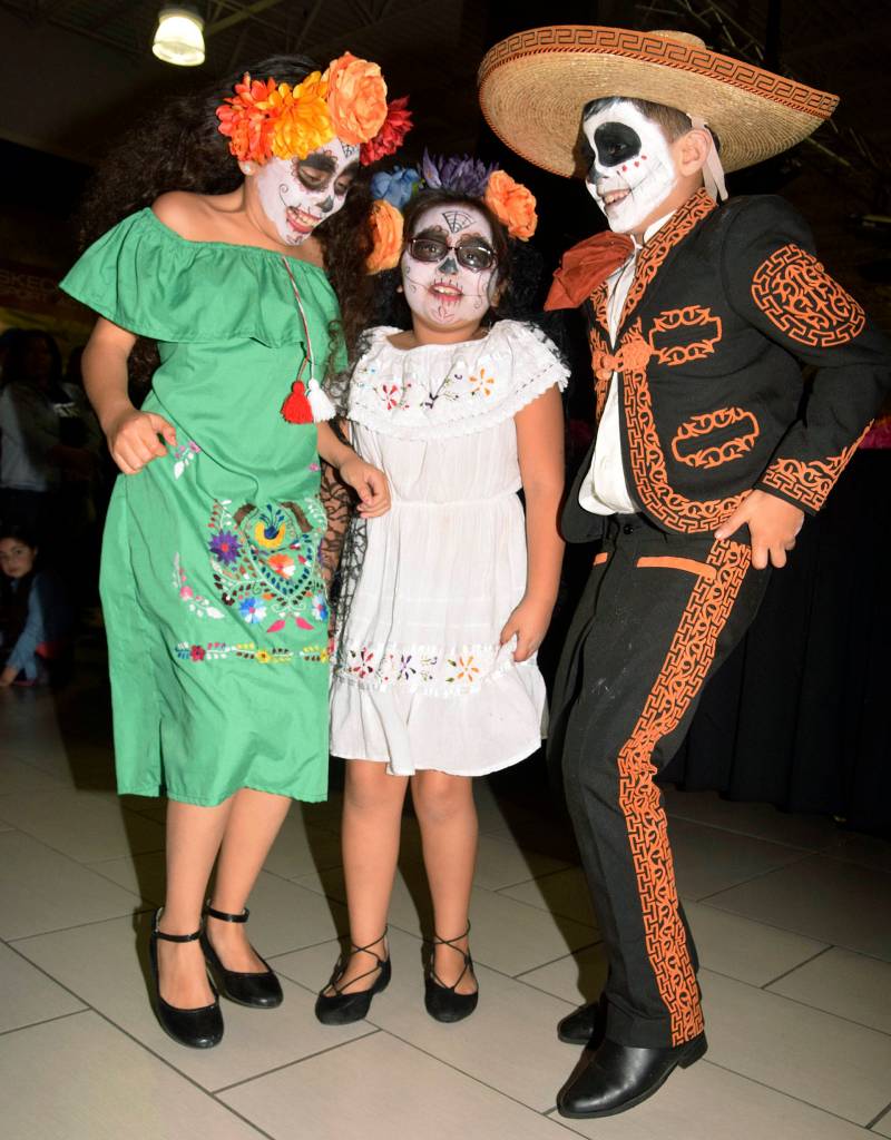 Jocelyn, 10, Breanna, 8, and Mauricio Ibarra, 9, dance to the music. RACHEL CIAMPI, Auburn Reporter
