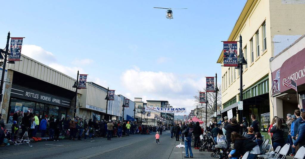 People watch as helicopter flies over Main Street at the start of the parade. RACHEL CIAMPI, Auburn Reporter