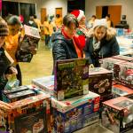 Moms go shopping for their children during the Smiles at Christmas, a free holiday toy giveaway event at Overcomer Covenant Church. COURTESY PHOTO, Brandon Patoc