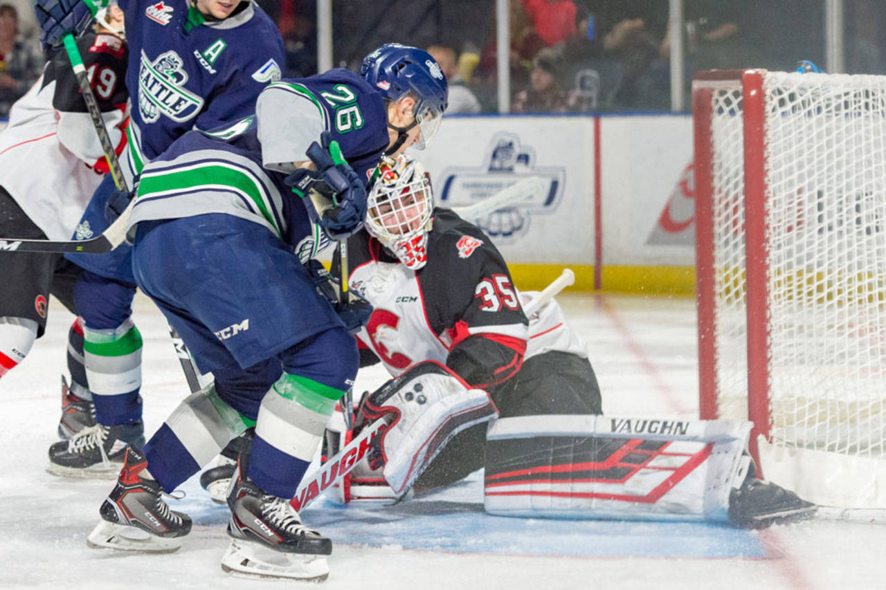 The Thunderbirds Nolan Volcan works to push the puck past Prince George goalie Taylor Gauthier during WHL play Tuesday night. COURTESY PHOTO, Brian Liesse, T-Birds