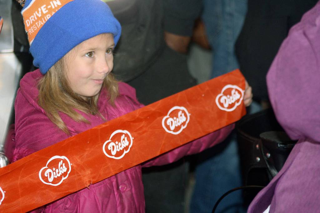 Bryn Holt, 6, helps celebrate the grand opening Wednesday in Kent of Dicks Drive-In. STEVE HUNTER, Kent Reporter