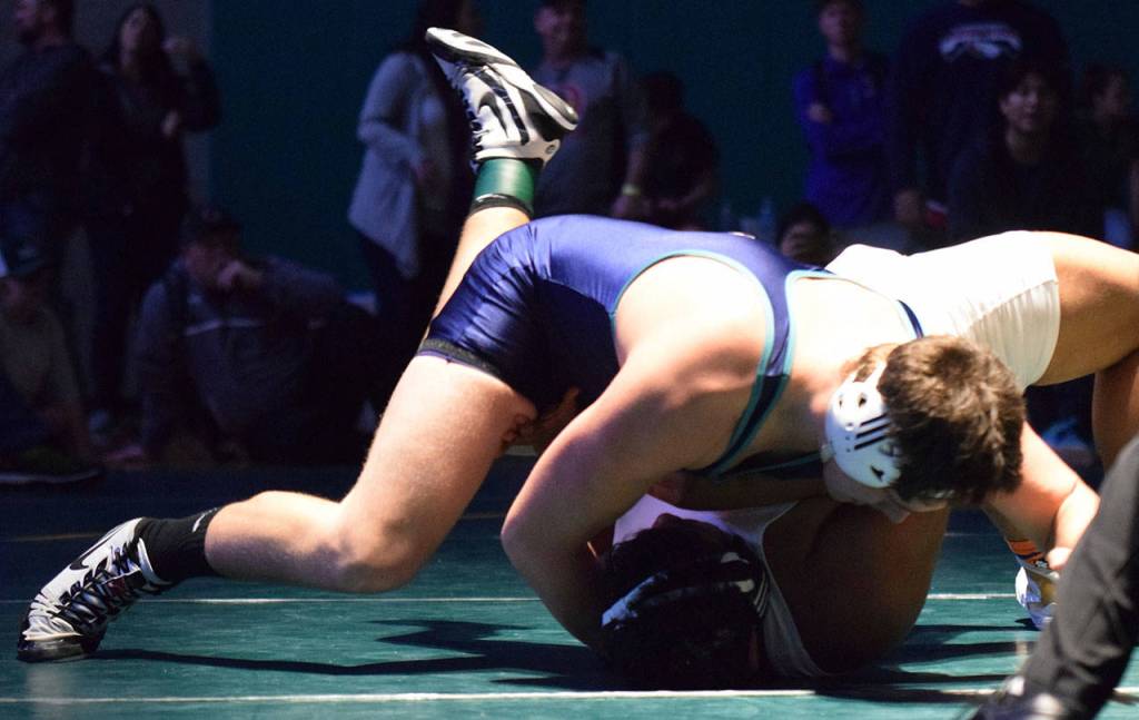 Auburn Riversides William Russell ties up Auburns Uriel Parra en route to claiming the 220-pound title at the Doc Herren Invitational last Saturday. RACHEL CIAMPI, Auburn Reporter
