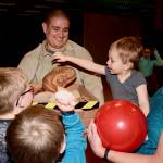 Omar Nava shows Lucy the baby dinosaur to kids. RACHEL CIAMPI, Auburn Reporter
