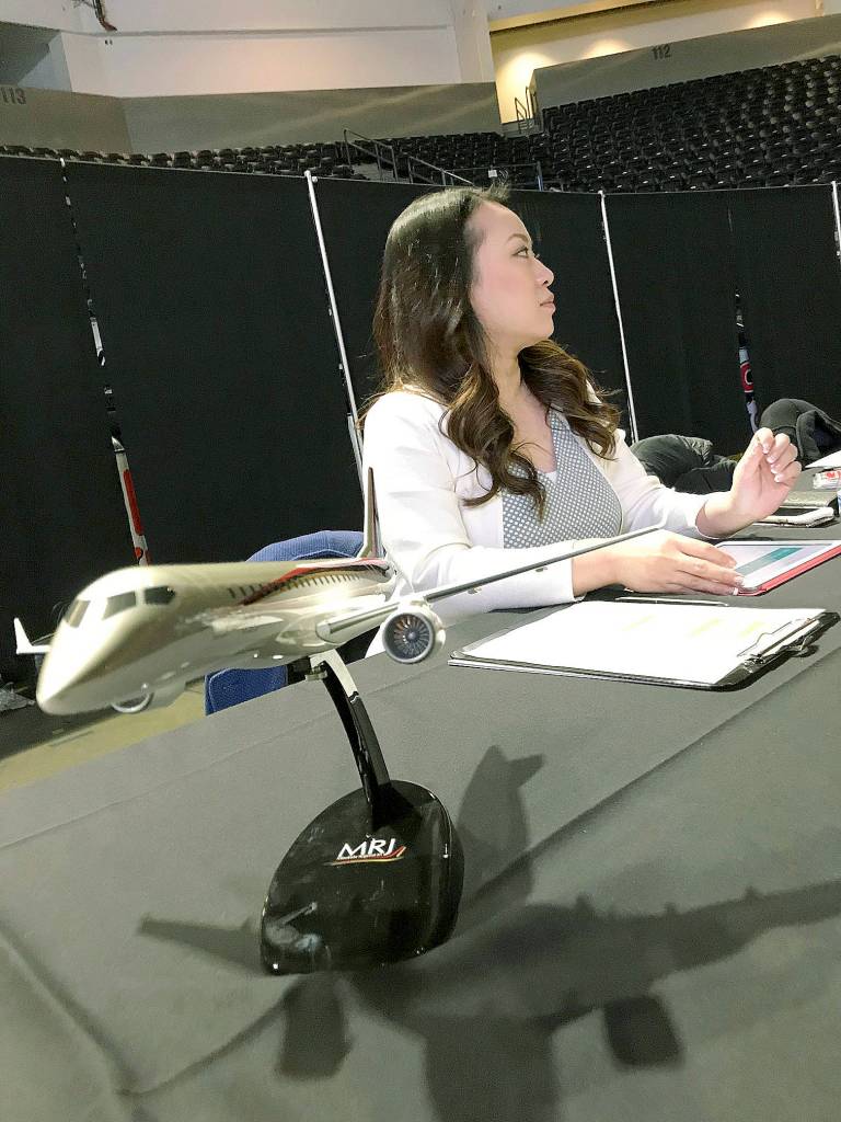 Hiromi Parcasio, a recuiter for Mitsubishi Aircraft Corporation America, Inc., awaits the next job-seeking customer during the AFA Aerospace Job Fair. MARK KLAAS, Auburn Reporter