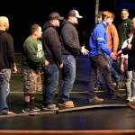 Auburn coach Matt Hoover welcomes and thanks the Trojans many past wrestling champions and coaches during pre-match ceremonies last Wednesday, Jan. 9, at the Auburn Performing Arts Center. RACHEL CIAMPI, Auburn Reporter