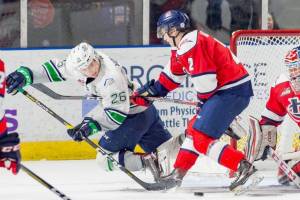 The Thunderbirds Nolan Volcan tries to move the puck in front of Hurricanes defenseman Calen Addison and Lethbridge keeper Carl Tetachuk during WHL play Friday night at the accesso ShoWare Center. COURTESY PHOTO, Brian Liesse/T-Birds