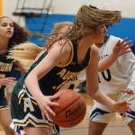 Auburns Emily Strojan dribbles past Auburn Riversides Carol Chikusa and others during NPSL Olympic play Friday night. Strojan scored a game-high 16 points. RACHEL CIAMPI, Auburn Reporter