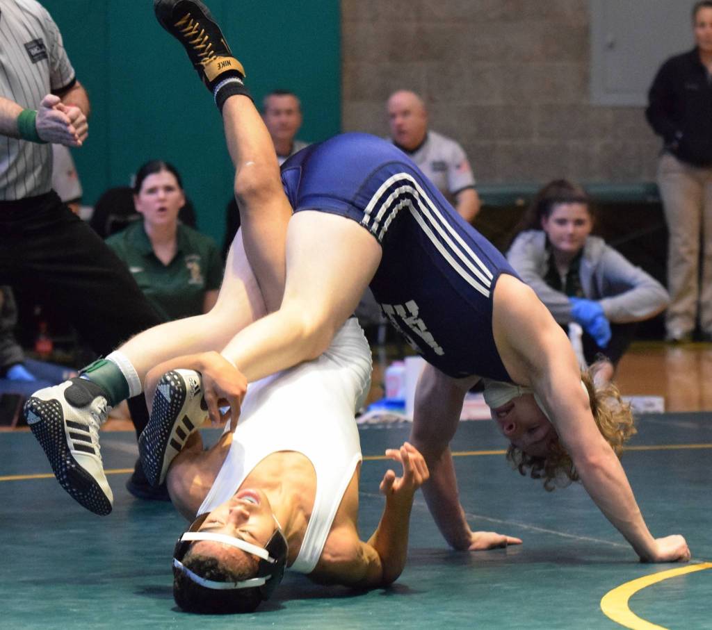 Auburn Riversides Jaden Cassel, top, ties up Auburns Dalton Whitehall-Gilkes in the 113-pound final. Cassel won by technical fall. RACHEL CIAMPI, Auburn Reporter
