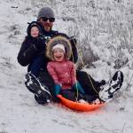 Steve Martin slides down a snow-caked hill in Auburn, with his kids Aevri, 3, and Eathan, 7 months, on Monday. A winter storm blasted Auburn and the greater valley overnight, closing schools, roads and canceling activities. The freeze canceled classes and impacted those working Monday and Tuesday. Schools reopened Wednesday. RACHEL CIAMPI, Auburn Reporter