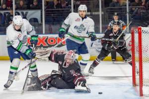 The Thunderbirds Henrik Rybinski slides the puck past Rebels goalie Byron Fancy during WHL play Friday night. COURTESY PHOTO, Brian Liesse, T-Birds