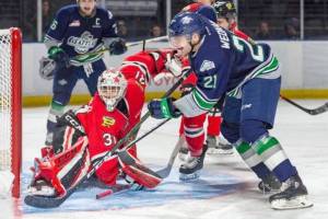 The Thunderbirds Matthew Wedman tires to rifle the puck past Winterhawks goalie Joel Hofer during WHL play Saturday night in Kent. COURTESY PHOTO, Brian Liesse, T-Birds