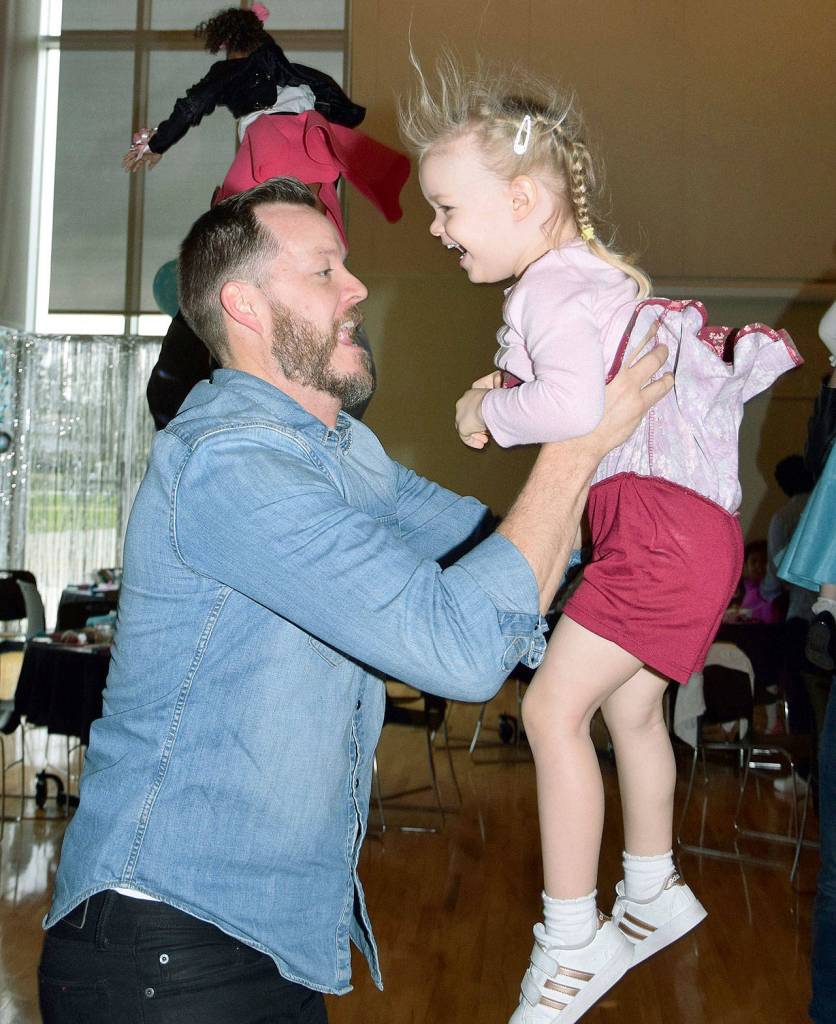 Steve Martin lifts his daughter Aevri, 3, at the dance. RACHEL CIAMPI, Auburn Reporter