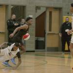 Roman Lewis (Graham-Kapowsin) of the 4A East team takes the ball up court as West defender DaeKwon Watson (Auburn) tumbles to the floor during the Sterling Athletics South Sound All-Star Game last Friday night. MARK KLAAS, Auburn Reporter