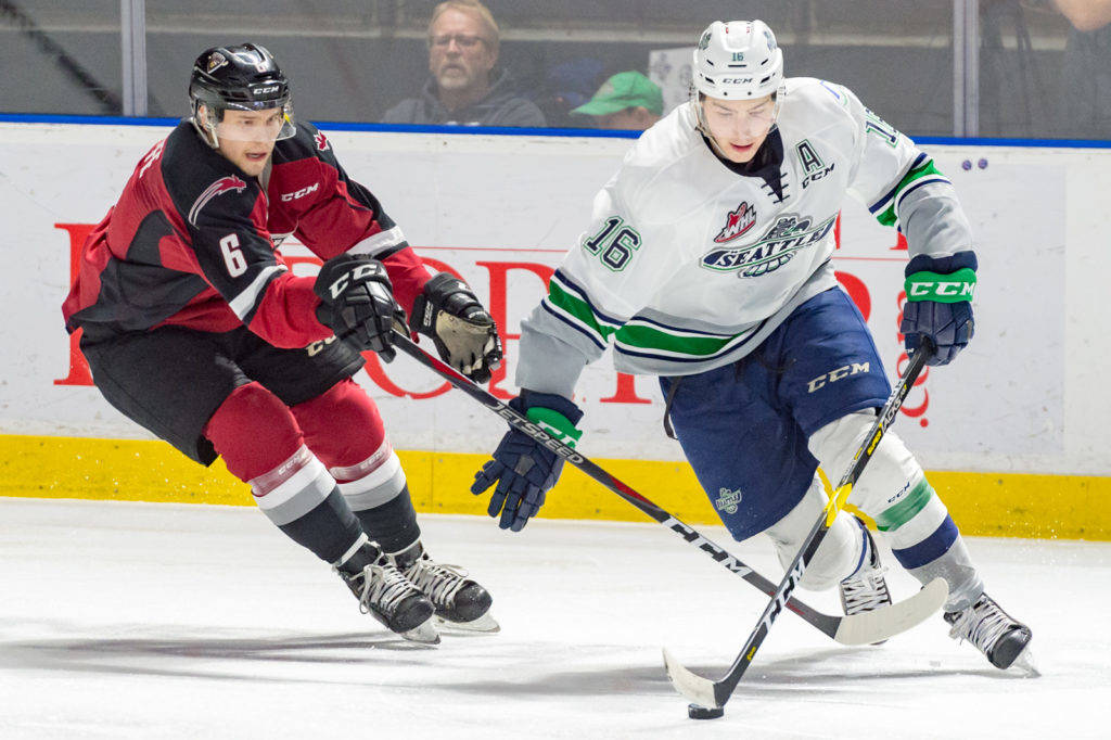 Thunderbirds center Noah Philp pushes the puck up the ice with the Giants Dylan Plouffe during Game 6 action Saturday night. COURTESY PHOTO, Brian Liesse, T-Birds