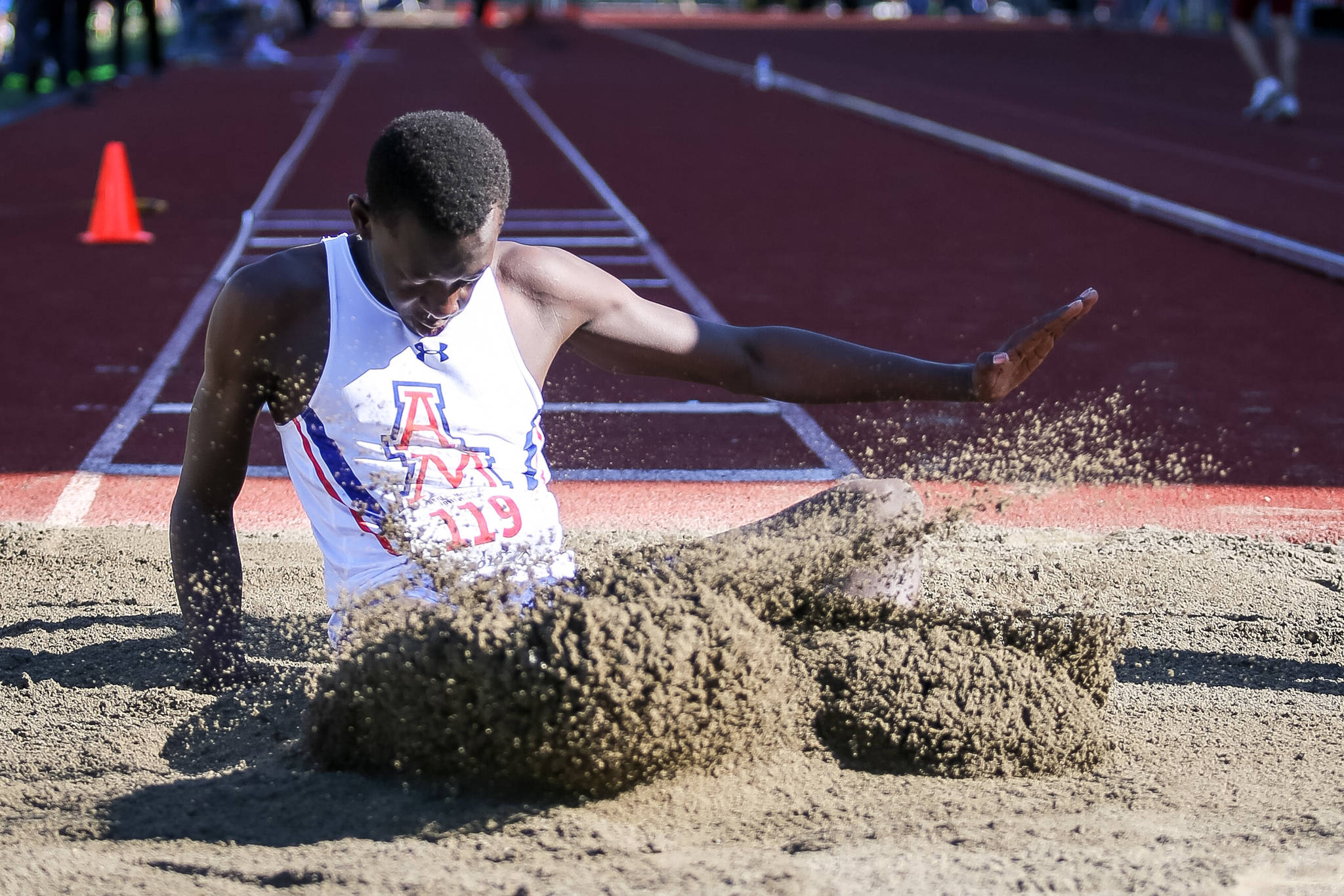 Auburn Mountainviews Bill Benjamin scatters the sand after an attempt in the triple jump during the Kent-Meridian Track and Field Invitational at French Field last Saturday. Benjamin finished fourth with a leap of 41 feet, one-half inch. COURTESY PHOTO, Bob Sheldon
