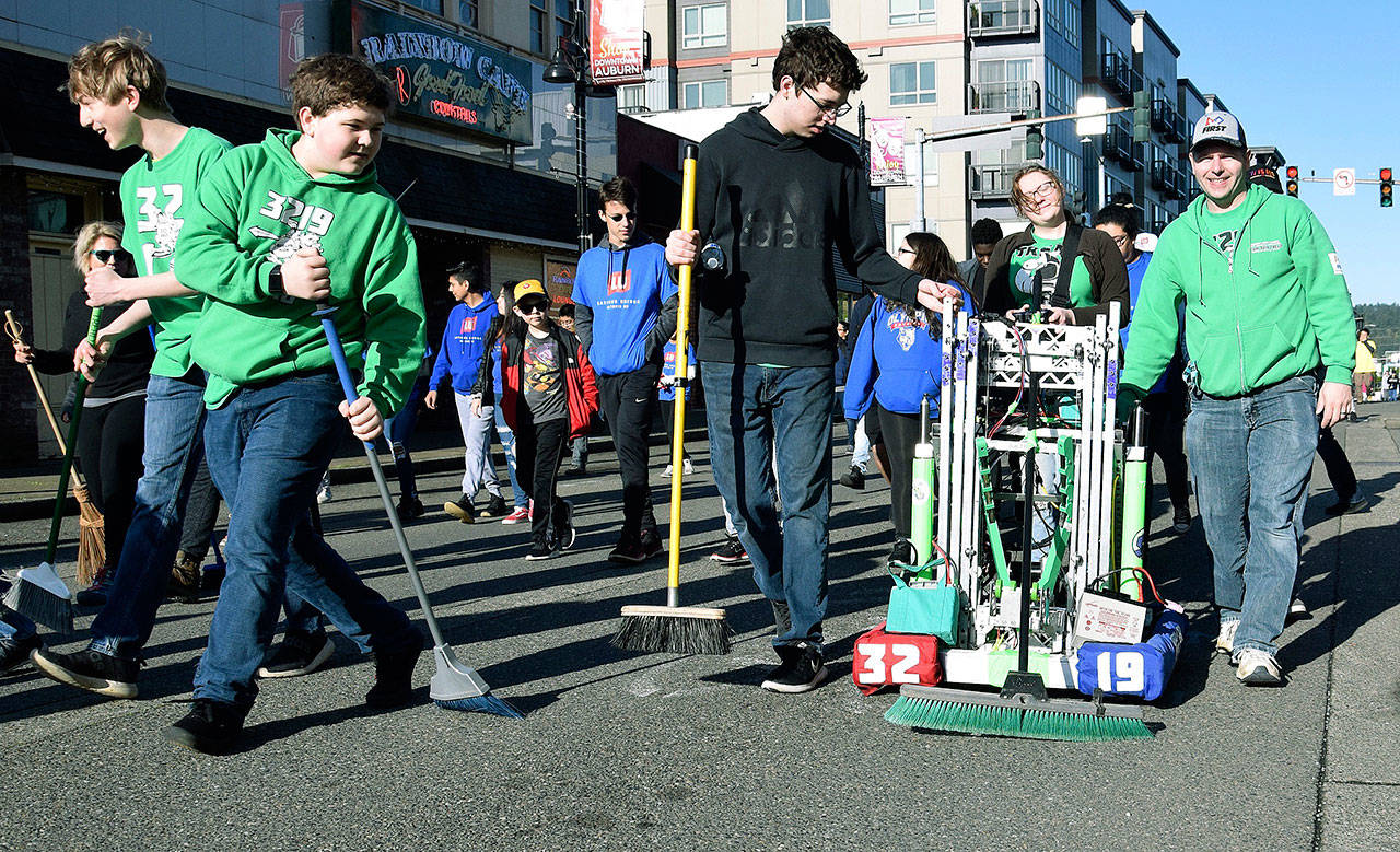 Auburn High School Robotics Club members and their resilient robot scour Main Street during Clean Sweep on Saturday. RACHEL CIAMPI, Auburn Reporter