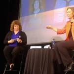U.S. Rep. Kim Schrier, right, answers questions submitted to her by constituents and collected by Auburn Mayor Nancy Backus, left, during her town hall appearance at Green River College on April 17. ROBERT WHALE, Auburn Reporter