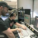 Green River College student Natalie Holcomb, right, cues up the next song in the KGRG-FM studio, with Chris Wilson, a student and the radio stations assistant program director, monitoring the sound. Holcomb, who is finishing her time at the college, has worked part-time in the promotion department at the local Entercom Radio stations (KISW, KNDD, Hot 103.7, The Wolf, 94.1 The Sound). COURTESY PHOTO, KGRG-FM