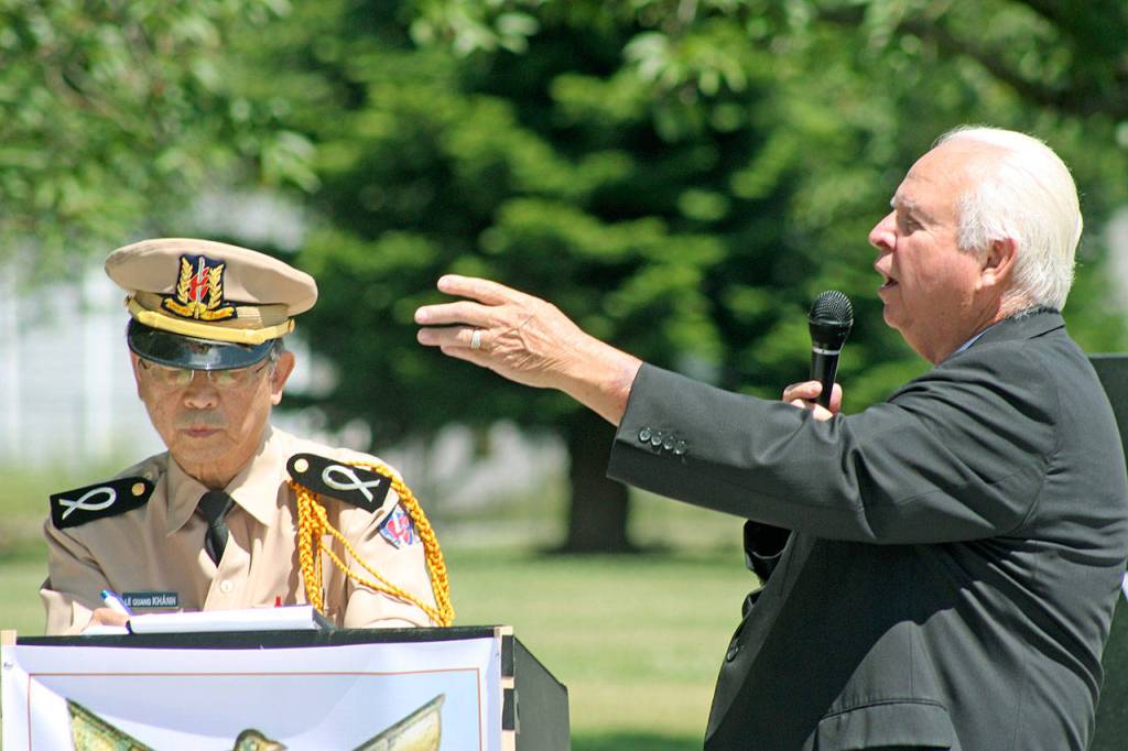 Former Auburn Mayor Pete Lewis welcomes and thanks those attending the gathering with the help of Khanh Le, an interpreter with the Thu-Duc Academy Association. MARK KLAAS, Auburn Reporter