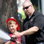 VRFA firefighter Daris Conrad shows a young volunteer how to work the hose. MARK KLAAS, Auburn Reporter
