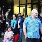 Attendees of the Drag Queen Story Hour at the Fairwood Library exit the event. A walkway was held open for them by supporters while protesters held signs condemning the event behind them. Aaron Kunkler/staff photo