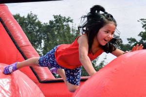 Valeria Del Razo Artadi jumps on the inflatable during the Fourth of July Festival last year to Les Gove Park. RACHEL CIAMPI, Auburn Reporter