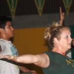 Katie Henry, Auburn High School athletics director and certified yoga instructor, leads a class of about 75 student-athletes through the many poses of the discipline Monday morning inside the schools wrestling gym. MARK KLAAS, Auburn Reporter