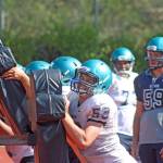 Auburn Riverside linemen push and lift the sled during summer camp drills Tuesday. MARK KLAAS, Auburn Reporter
