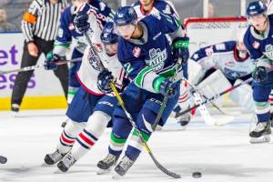 Thunderbirds center Henrik Rybinski battles the Americans Zane Franklin in bringing the puck up the ice Friday night. COURTESY PHOTO, Brian Liesse, T-Birds