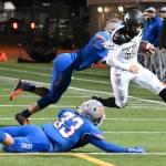 Kentwood quarterback Jackson Proctor dashes goal-ward as Auburn Mountainviews Teagin Child and Cooper White (33) pursue during NPSL first-half play Friday night. RACHEL CIAMPI, Auburn Reporter