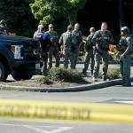 King County Sheriffs Office detectives and SWAT team members debrief at the scene of an officer-involved shooting on Wednesday afternoon in Federal Way. OLIVIA SULLIVAN, Federal Way Mirror
