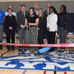 Auburn School District members and Olympic Students hold the ribbons as ASB Olympic President Denise De La Mora makes to cut. RACHEL CIAMPI, Auburn Reporter