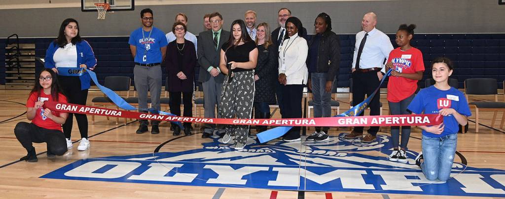 Auburn School District members and Olympic Students hold the ribbons as ASB Olympic President Denise De La Mora makes to cut. RACHEL CIAMPI, Auburn Reporter