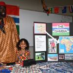 Abbas Jagne and his daughters, Khadi Jagne, 3, and Sandra Jagne, 5, at the Gambia Table. RACHEL CIAMPI, Auburn Reporter