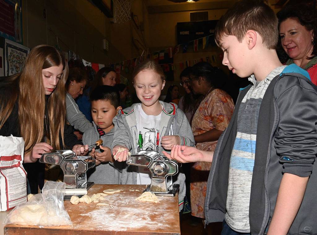 Adriana, 14, and Isabella LoPriore, 10, show kids how to make noodles at the Italy Table. RACHEL CIAMPI, Auburn Reporter
