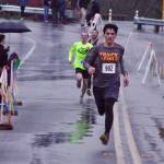 Enumclaws Dominic Deady, 19, kicks to the wire to take the mens 5K. MARK KLAAS, Kent Reporter