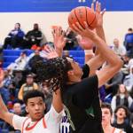 Trojans drive past Ravens, grab a share of league title