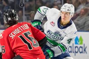 The Thunderbirds Lucas Ciona and the Cougars Ryan Schoettler fight for the puck during WHL play Sunday. COURTESY PHOTO, Brian Liesse, T-Birds