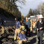 Firefighters work the scene after rescuing a man who was buried to his waist in rock and first when a portion of a retaining wall reportedly collapsed. COURTESY PHOTO, VRFA