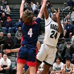 Auburns DaeKwon Watson releases a shot over Kennedy Catholics Reece McAllister during district playoff action Wednesday. RACHEL CIAMPI, Auburn Reporter